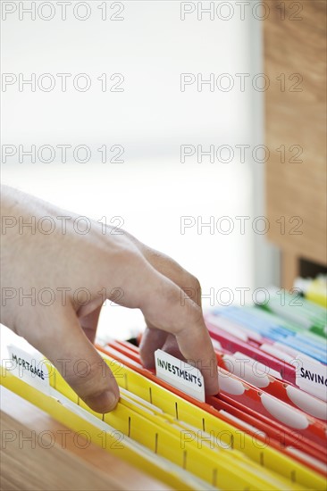 Hand searching in files drawer. 
Photo: Elena Elisseeva