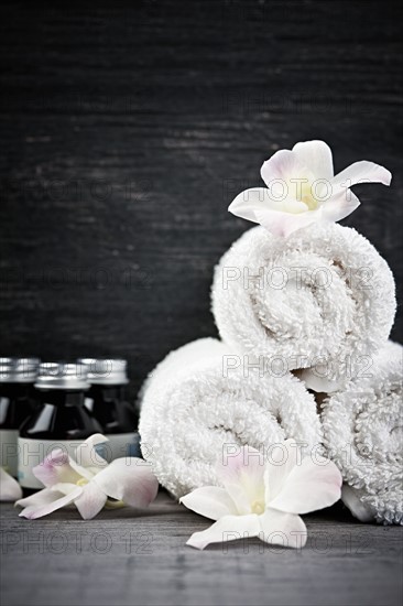 Still life with bottles, flowers and towels. 
Photo: Elena Elisseeva