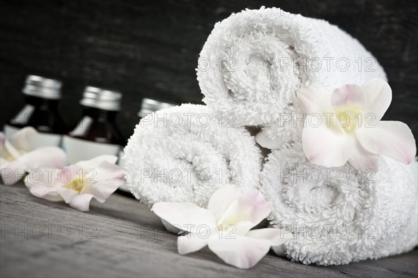 Still life with bottles, flowers and towels. 
Photo : Elena Elisseeva