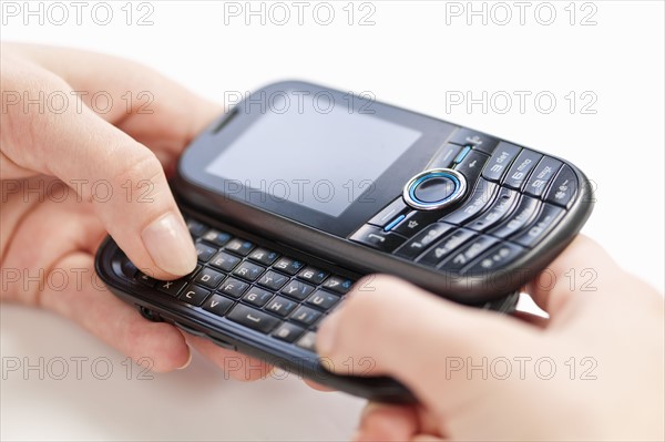 Sending text message, studio shot. 
Photo: Elena Elisseeva