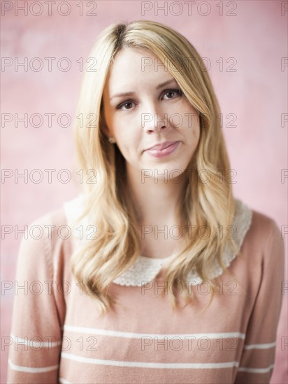 Portrait of young smiling woman, studio shot. 
Photo: Jessica Peterson