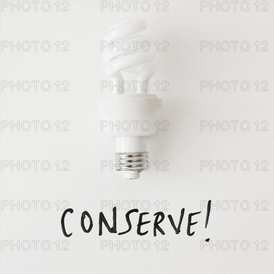 Energy efficient light bulb on white background, studio shot. 
Photo : Jessica Peterson