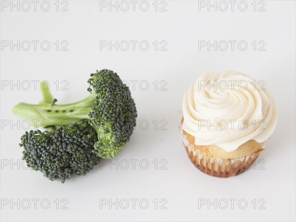 Broccoli and muffin on white background, studio shot. 
Photo: Jessica Peterson