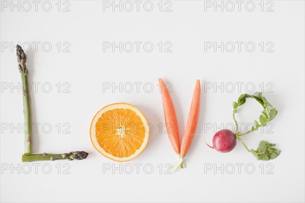 Word 'love' made out of fruits and vegetables, studio shot. 
Photo : Jessica Peterson