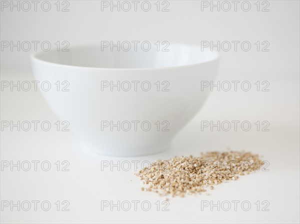Bowl and wheat seed on white background, studio shot. 
Photo : Jessica Peterson