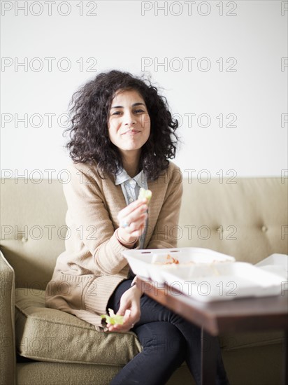 Smiling young woman having take away food. 
Photo: Jessica Peterson