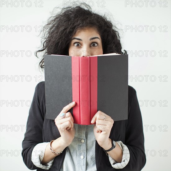 Happy young woman posing with book. 
Photo: Jessica Peterson