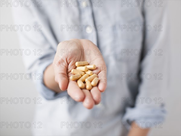 Woman showing handful of pills. 
Photo : Jessica Peterson