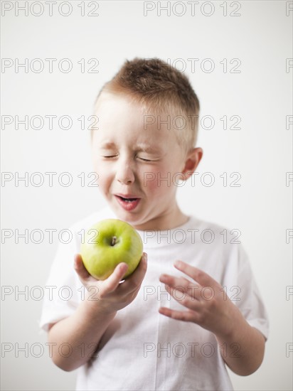 Portrait of toddler boy (2-3) playing with green apple. 
Photo: Jessica Peterson