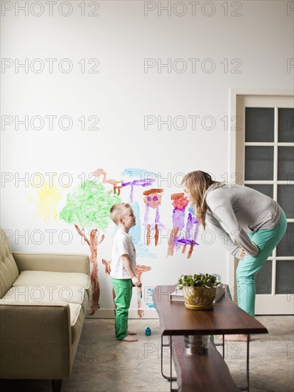 Mother telling toddler boy (2-3) off for painting on walls. 
Photo: Jessica Peterson