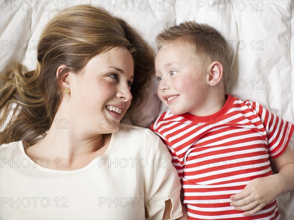 Mother and toddler boy (2-3) lying in bed . 
Photo : Jessica Peterson