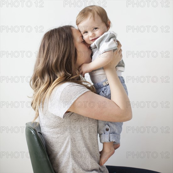 Portrait of young woman embracing baby boy (6-11 months).
Photo: Jessica Peterson