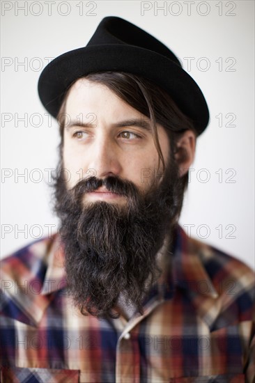 Profile of male character wearing long beard, hat and lumberjack shirt. 
Photo: Jessica Peterson