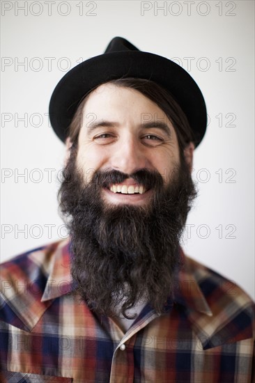 Profile of male character wearing long beard, hat and lumberjack shirt. 
Photo : Jessica Peterson