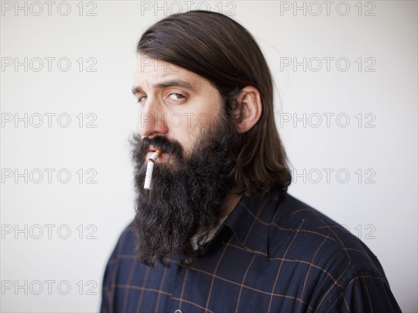 Bearded young man with broken cigarette in his mouth. 
Photo: Jessica Peterson