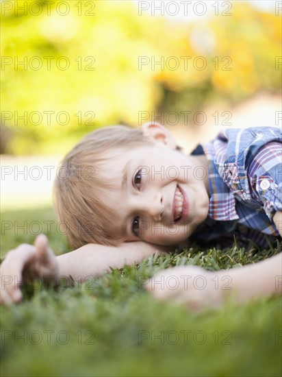 Outdoor portrait of happy young boy (6-7) . 
Photo: Jessica Peterson