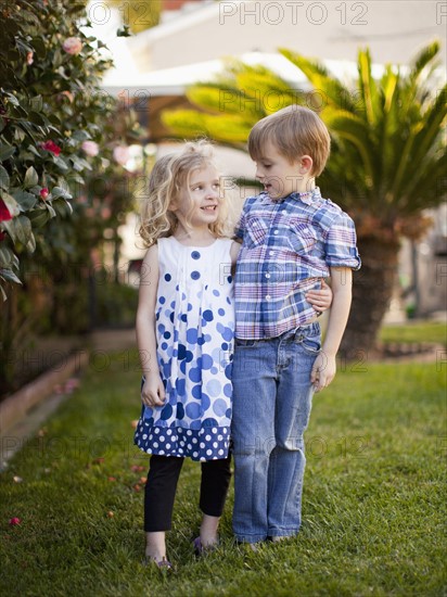 Outdoor portrait of girl (4-5) and boy (6-7) . 
Photo: Jessica Peterson