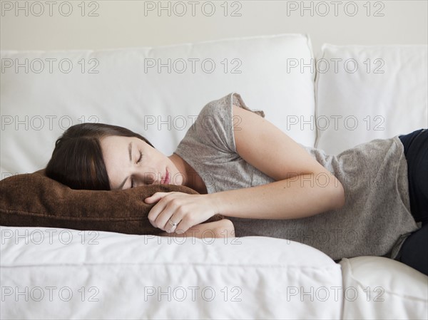 Young woman sleeping on sofa. 
Photo : Jessica Peterson