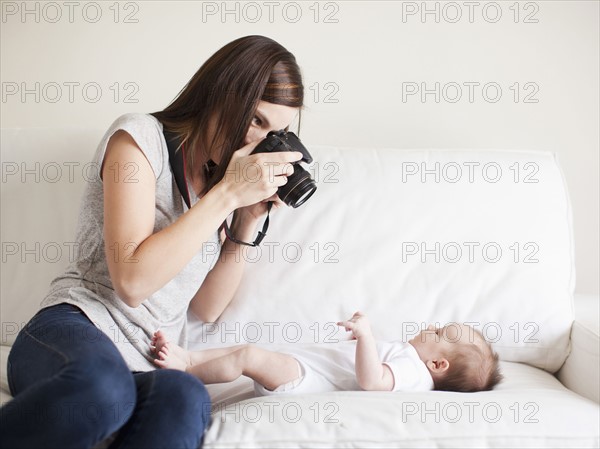 Mother photographing baby girl (2-5 months). 
Photo: Jessica Peterson