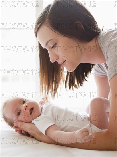 Mother changing baby girl (2-5 months). 
Photo : Jessica Peterson