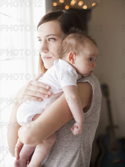 Mother embracing baby girl (2-5 months). 
Photo: Jessica Peterson