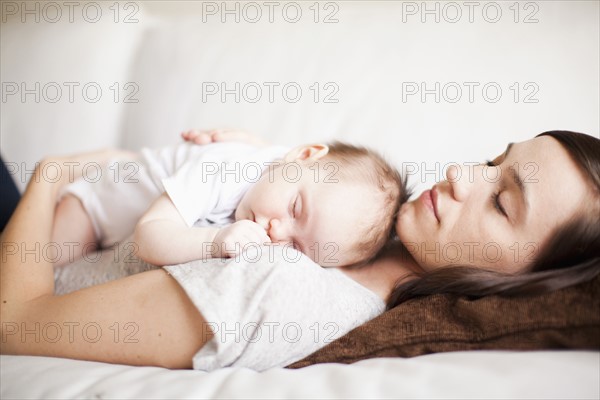 Mother and baby girl (2-5 months) sleeping together. 
Photo: Jessica Peterson