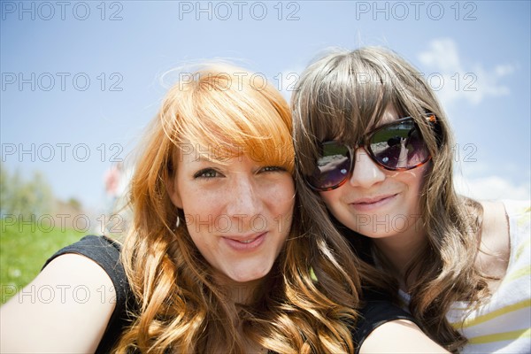 Two young female friends posing for portrait. 
Photo : Jessica Peterson