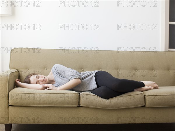 Young woman sleeping on sofa.
Photo : Jessica Peterson