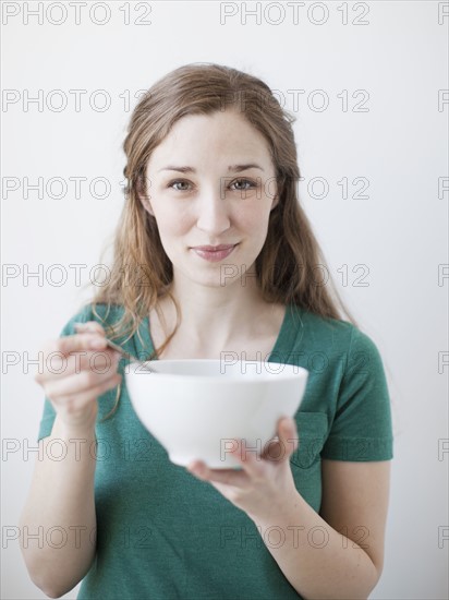 Happy young woman enjoying bowl of cornflakes. 
Photo: Jessica Peterson