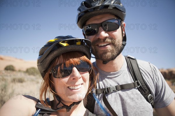 Outdoors portrait of couple in cycling gear. 
Photo: Jessica Peterson
