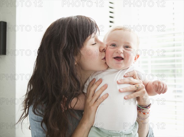 Young mother kissing baby boy (6-11 months) . 
Photo: Jessica Peterson