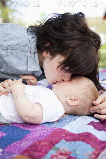 Young mother kissing baby boy (6-11 months) . 
Photo: Jessica Peterson