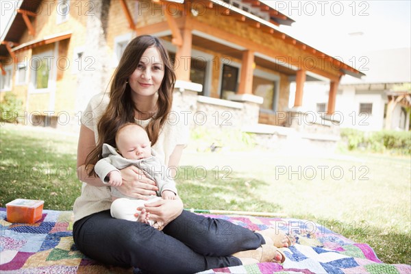 USA, Utah, Salt Lake City, Young mother with baby boy ( 2-5 months) lying on blanket.
Photo: Jessica Peterson
