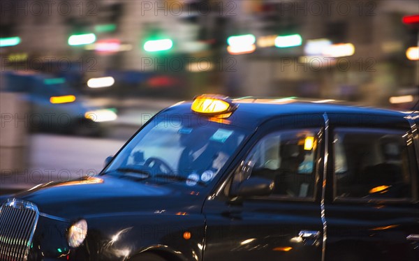 UK, London, Black cab at night.