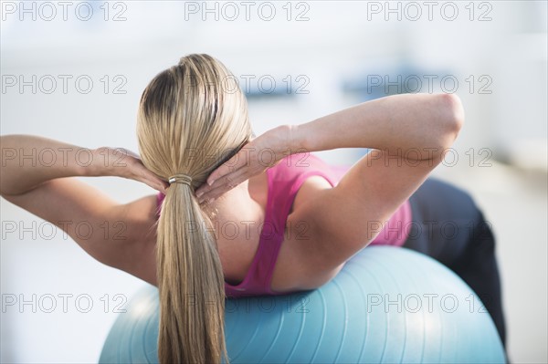 Woman exercising on fitness ball.