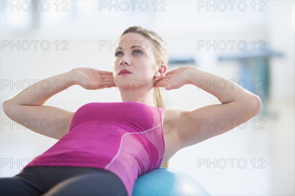 Woman exercising on fitness ball.