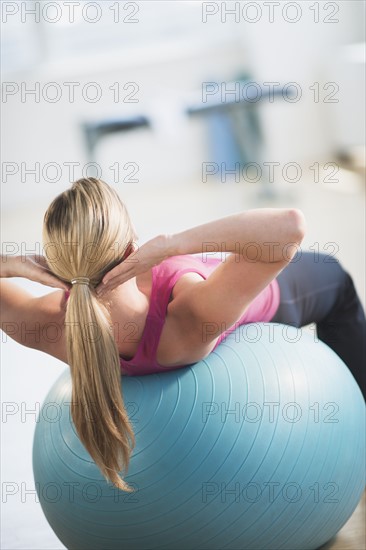 Woman exercising on fitness ball.