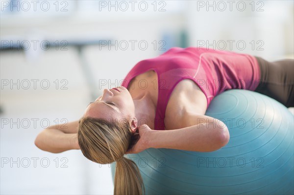 Woman exercising on fitness ball.