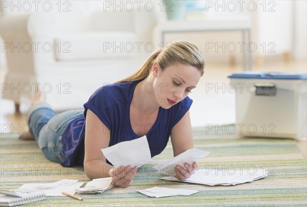 Woman looking at bills.