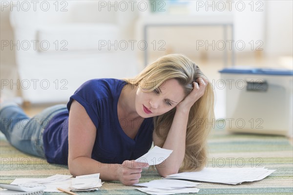 Woman looking at bills.