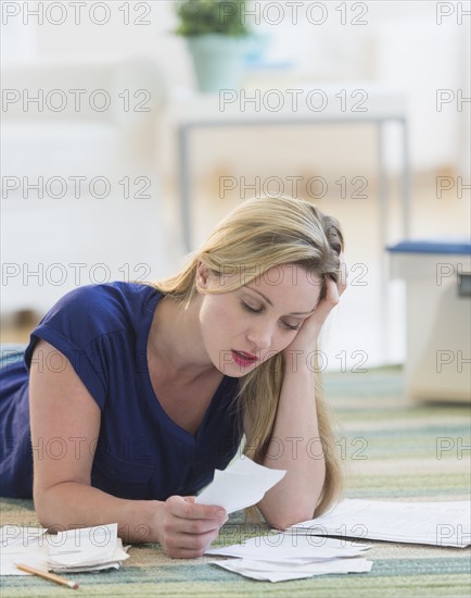 Woman looking at bills.