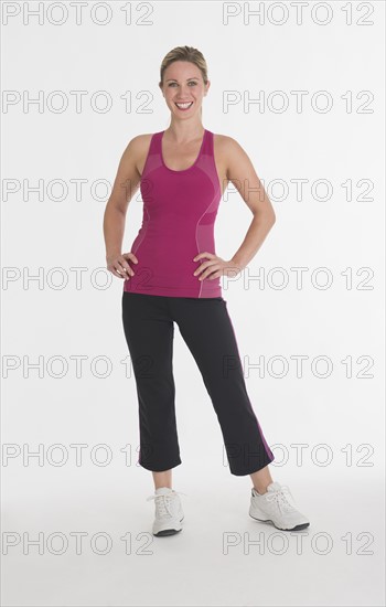 Studio portrait of woman in workout clothes.