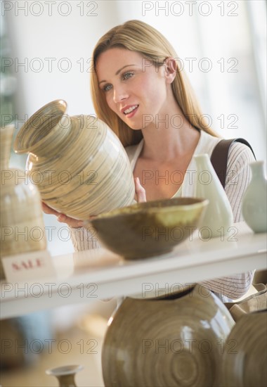 Woman buying pottery.