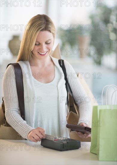 Woman paying with credit card.