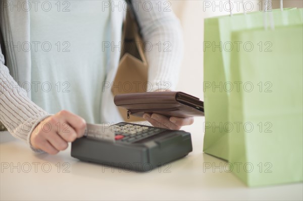 Woman paying with credit card.
