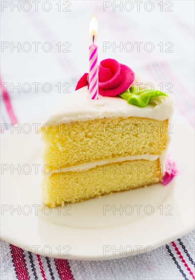 Slice of cake with candle.