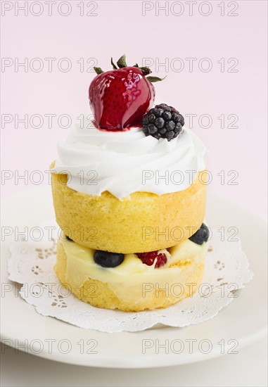 Cake with berries and whipped cream.