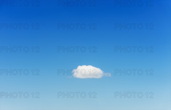 Blue sky with single cloud.