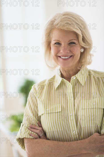 Portrait of mature woman in kitchen.