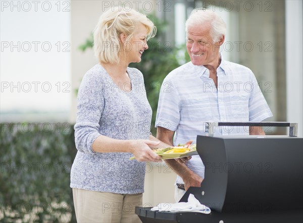 Couple enjoying barbecue.